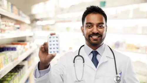 Pharmacist holding a blister pack of medication