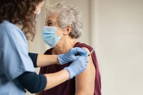 Pharmacist administering a vaccine to a patient