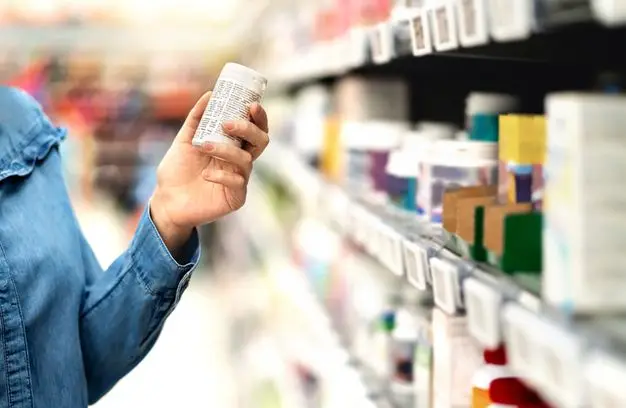 Customer choosing an over-the-counter product in the pharmacy aisle