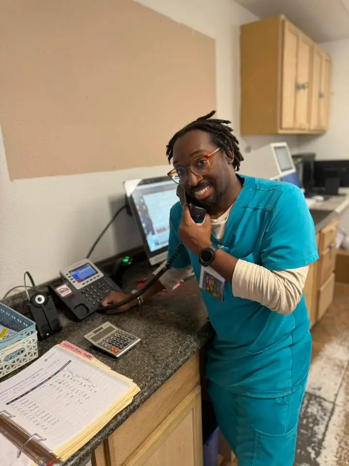 A Riverside Pharmacy team member taking a phone call at the counter